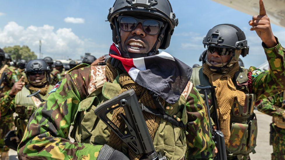 A policeman from the new Kenyan contingent reacts with his teammate - July 2024