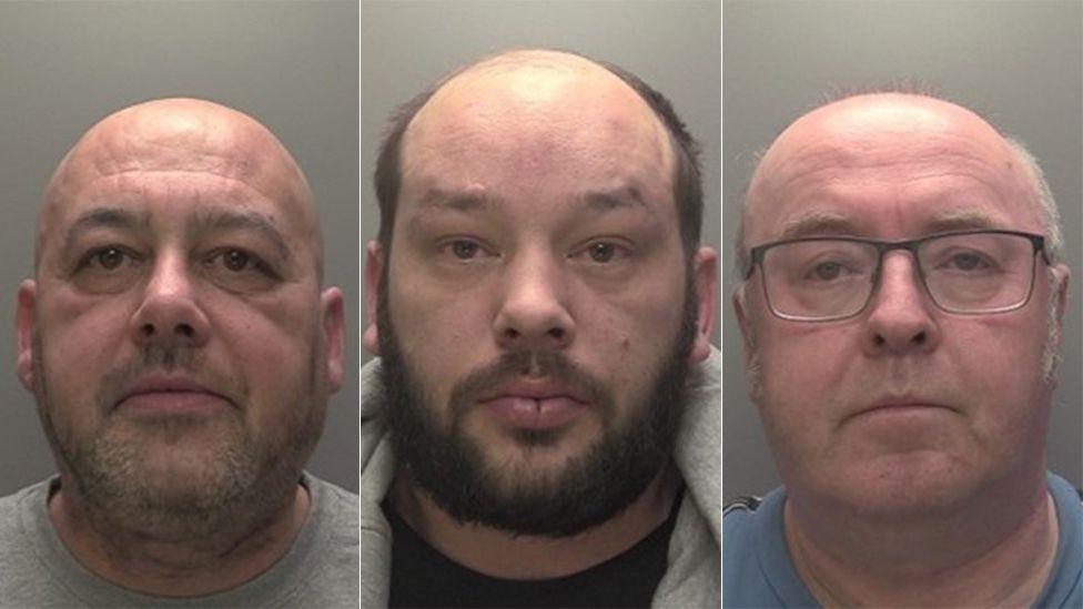 Police custody photographs of, from left to right, John Robinson, Christopher Coldbeck and Philip Melling. They are all bald and wearing dark tops. Melling is wearing glasses and Coldbeck has a dark beard