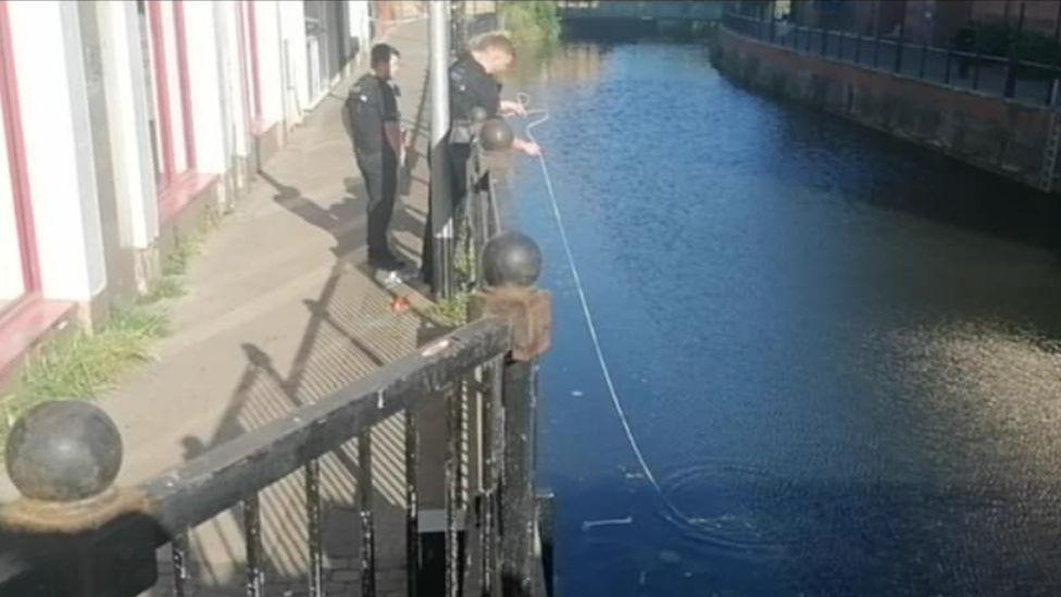 Police officers trying to scoop out the discovery from the river