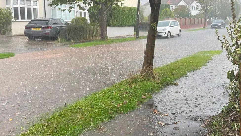 Heavy rain on a residential road in Gloucestershire