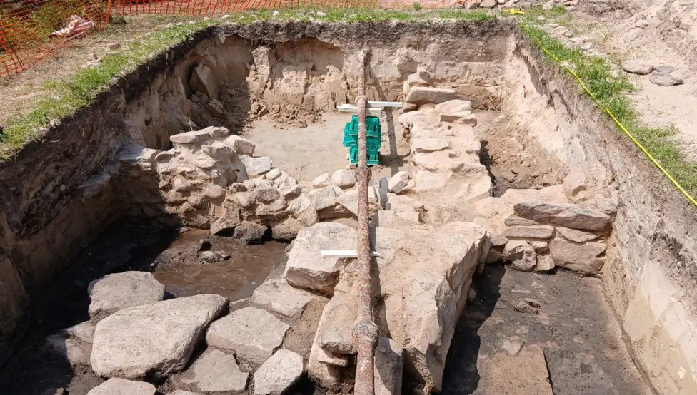 A 3m by 5m excavation uncovering part of an Iron Age round house.