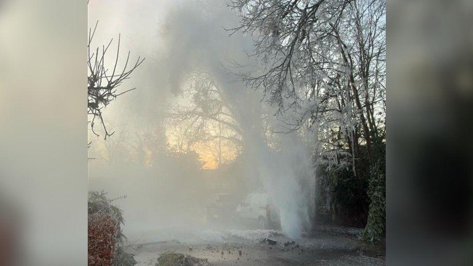 A burst water main spraying into the skies