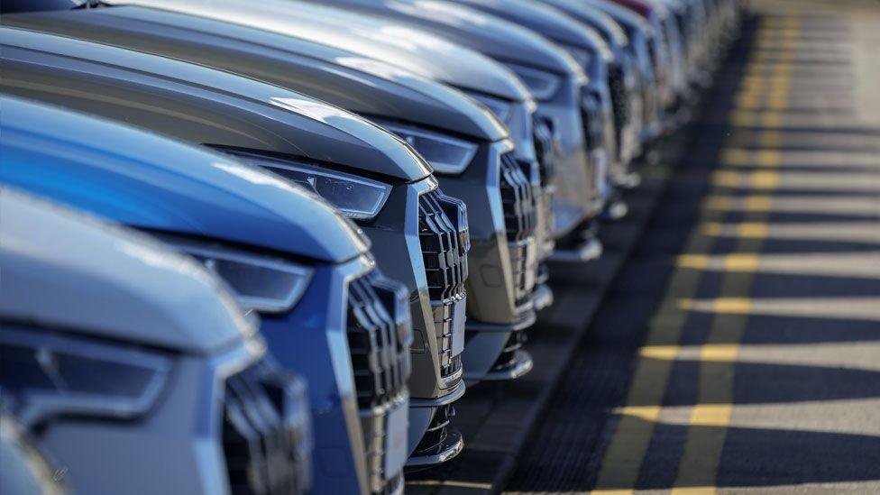 A row of cars at car dealership