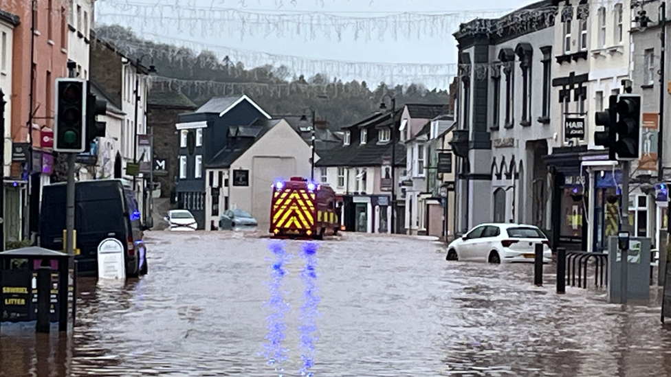 Vehicles in standing water up to their tyres