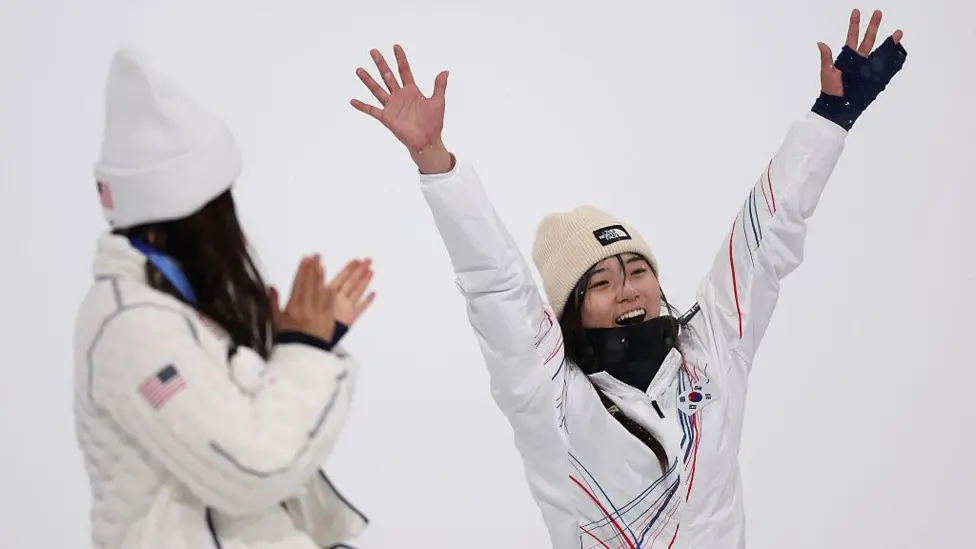 Choi Ga-on celebrates, watched on by Chloe Kim