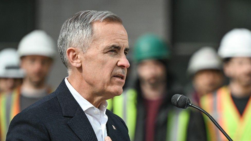 Mark Carney gives a speech in front of Canadian construction workers