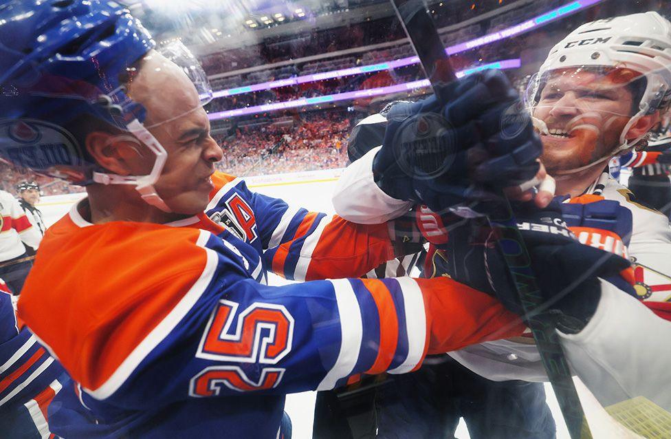 Darnell Nurse of the Edmonton Oilers battles with Matthew Tkachuk of the Florida Panthers during Game Two of the 2025 NHL Stanley Cup Final in Edmonton, Alberta. Photo by Bruce Bennett