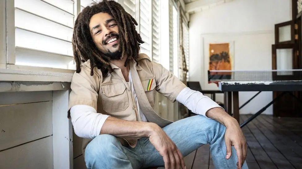 Kingsley Ben-Adir poses in a promotional photo for the film Bob Marley: One Love