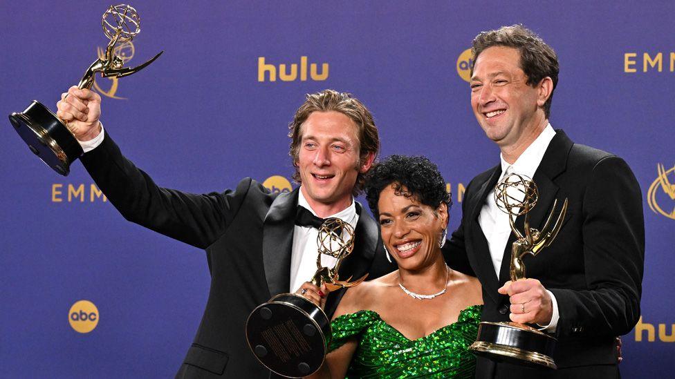 Jeremy Allen White, Liza Colon-Zayas and Ebon Moss-Bachrach pose together smiling with their Emmy Awards