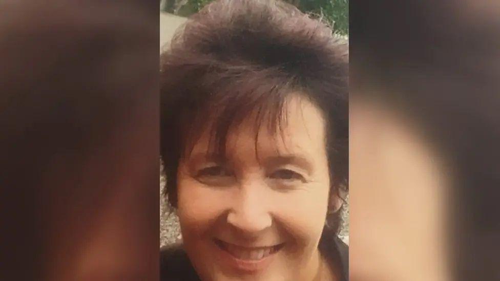 Paula Leeson smiles in a cropped photo. She has brown hair and a long fringe.