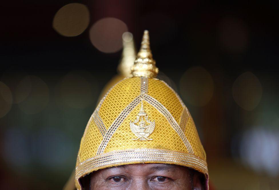 A Thai Royal Navy oarsman takes part in a ritual to worship Royal Barges to honour the king's 72nd birthday celebration in Bangkok, Thailand, 02 July 2024. The picture is a close-up image of the oarsman's eyes and helmet with is designed with gold