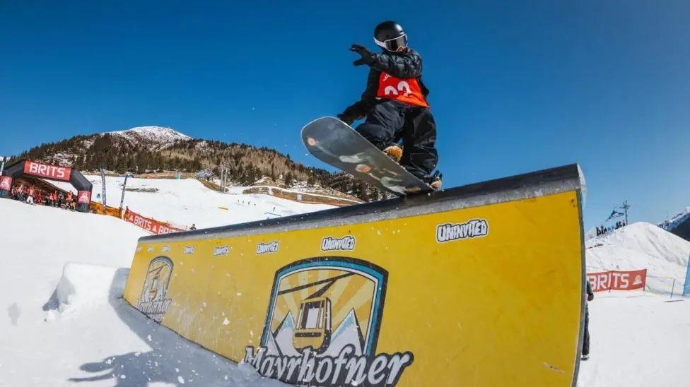 Riley age 10 rides a rail snowboarding