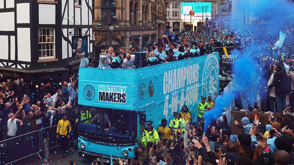 Manchester City's Erling Braut Haaland and Phil Foden with the Premier League trophy on the bus during the victory parade