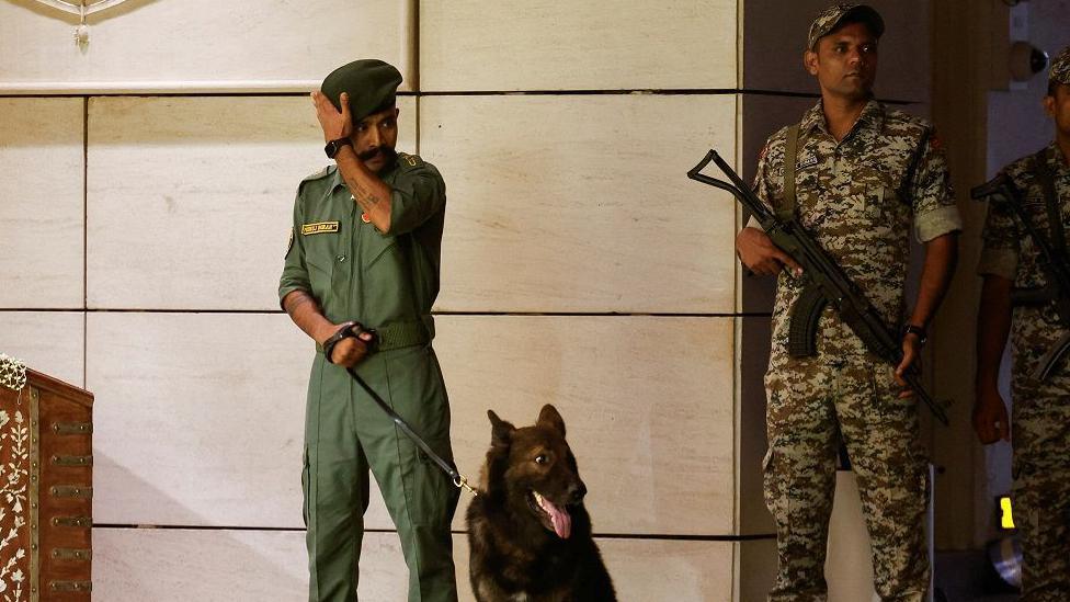 Security guards patrol the residence of Mukesh Ambani during the haldi function of Anant Ambani and Radhika Merchant before