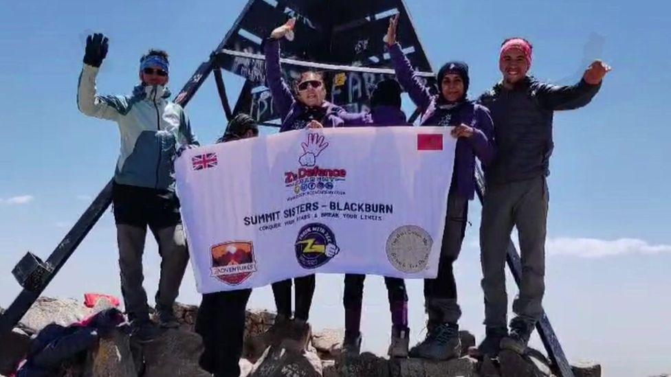 The women on the summit, with local guides