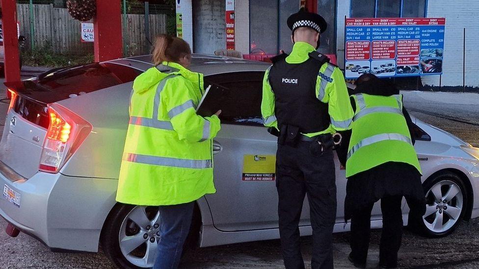 Police checking a taxi in Lancashire