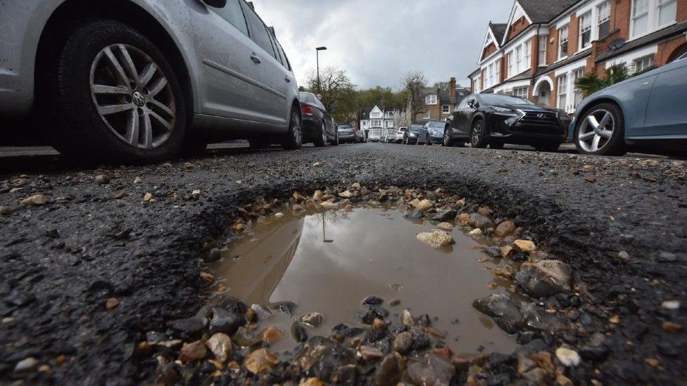 A pothole in a road