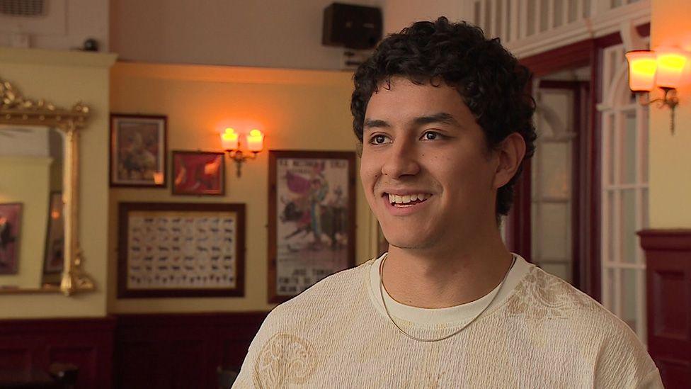 Diego Durán in a restaurant dining area, smiling