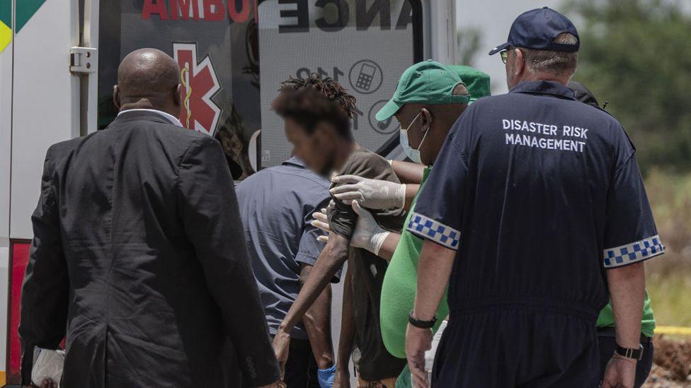 A miner who emerged from a disused mineshaft is being helped into an ambulance