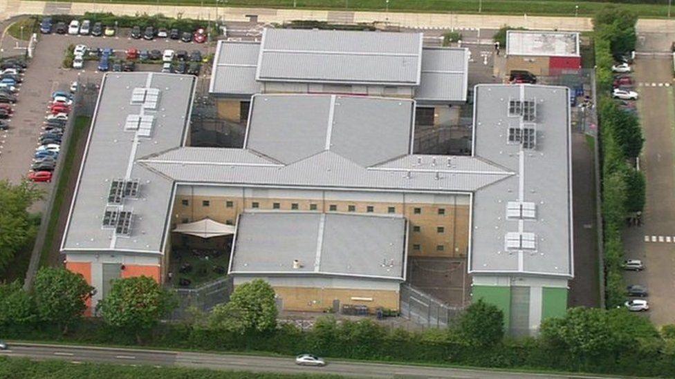 Brook House detention centre seen from the air. It is in a cross shape, and can be observed to be laid out in a wing type structure. 