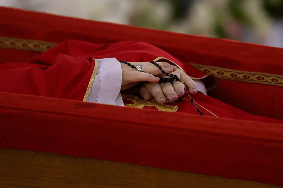Pope Francis's hands wrapped in rosary beads