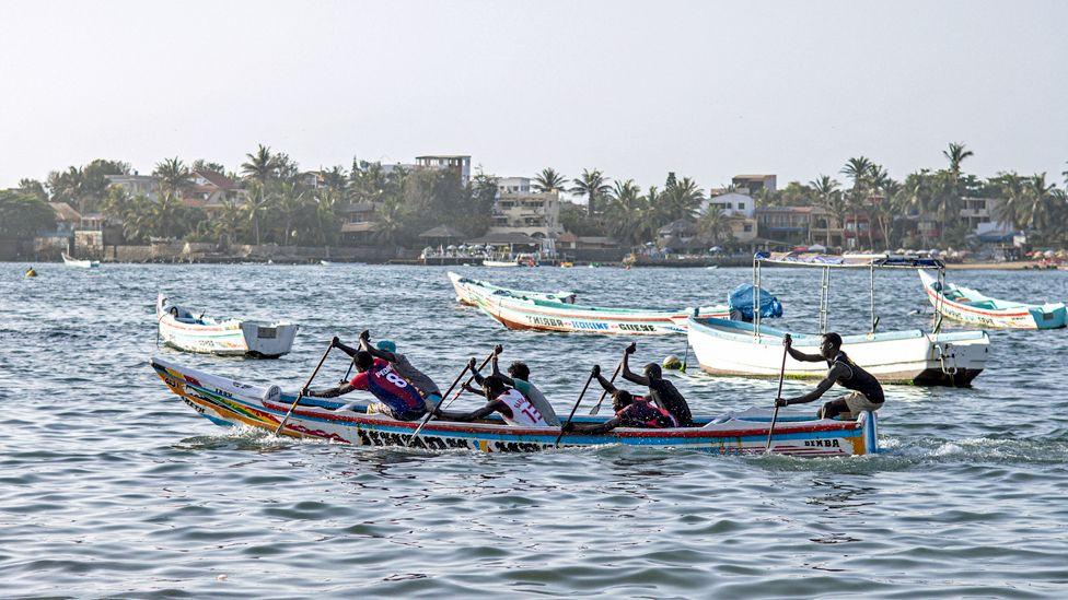 Competitors race in a pirogue boat during at a cultural event at Ngor beach in Dakar, Senegal – Wednesday 5 June 2024