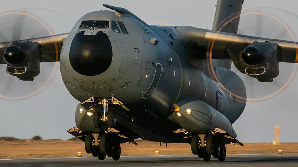 The A400M takes off from a runway in a desert region.