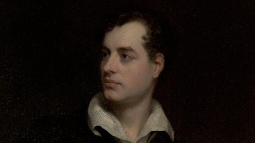 A young Bryon painted in oils, he has dark hair and dark eyes and a fair skin, and is wearing a white shirt which is open at the collar. 