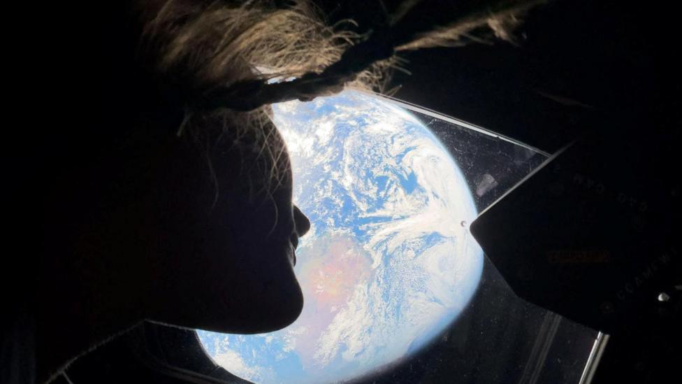 Astronaut Christina Koch watching Earth in a picture taken on an iPhone