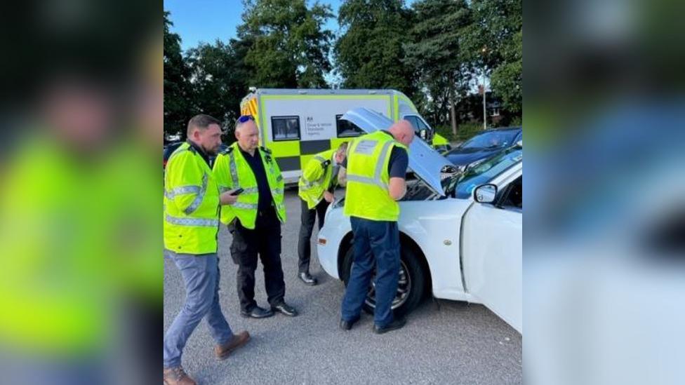 Officers inspect seized limousine