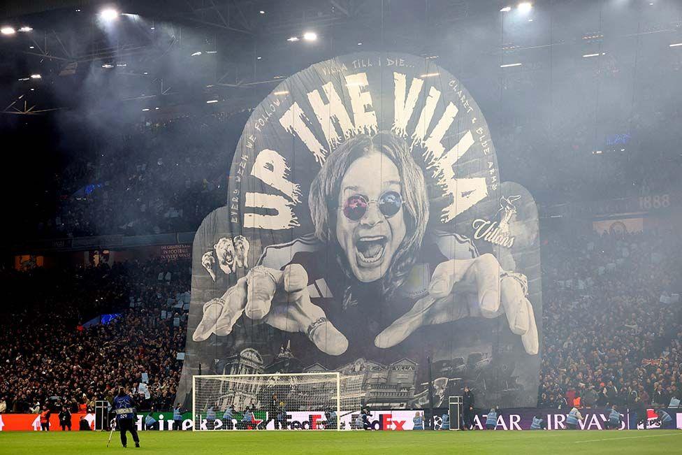 Aston Villa fans display a banner of musician Ozzy Osbourne behind the goal at Villa Park stadium.