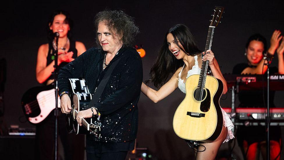 Robert Smith playing guitar with Olivia Rodrigo