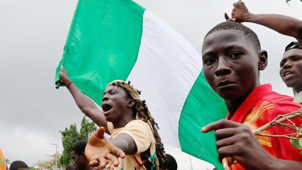 Protesters with a Nigerian flag in Abuja, Nigeria - 2 August 2024