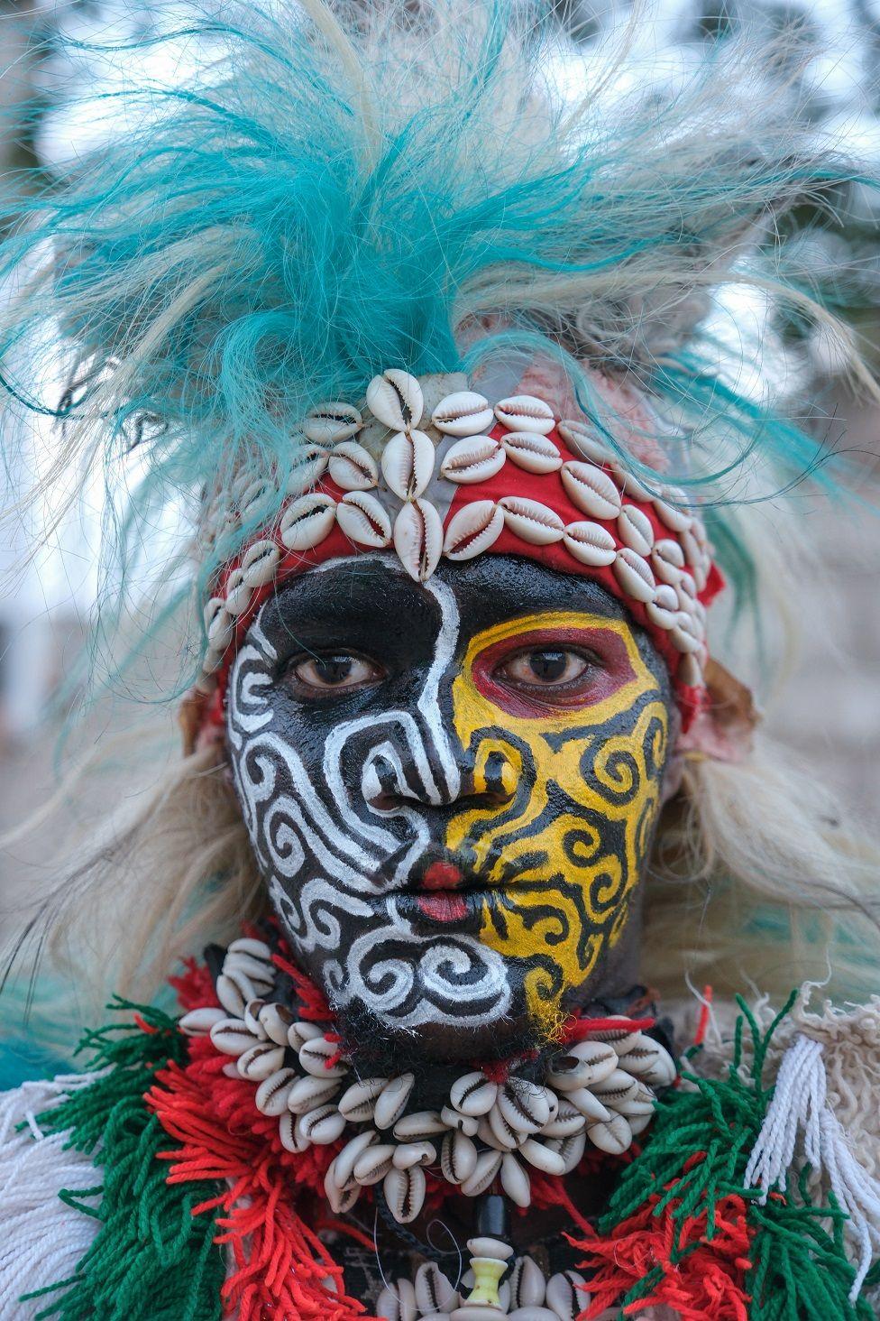 A performer poses in a traditional Simb costume during a cultural show at Ngor in Dakar, on August 12, 2024. The Simbs perform dances and rituals throughout the year in Senegal for various occasions, such as Independence Day, summer school break, wrestling matches and more. 