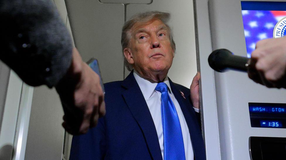 Trump speaking to reporters on Air Force One while returning to the US from the G7 summit in Canada