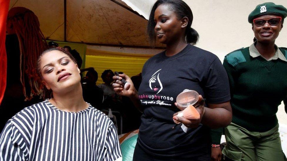 An inmate, receives makeup before participating in the annual Miss Langata Prison beauty show on 7 June. 