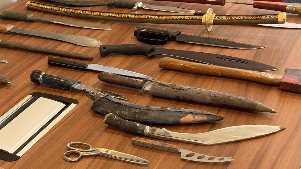 Knives laid out on an office table