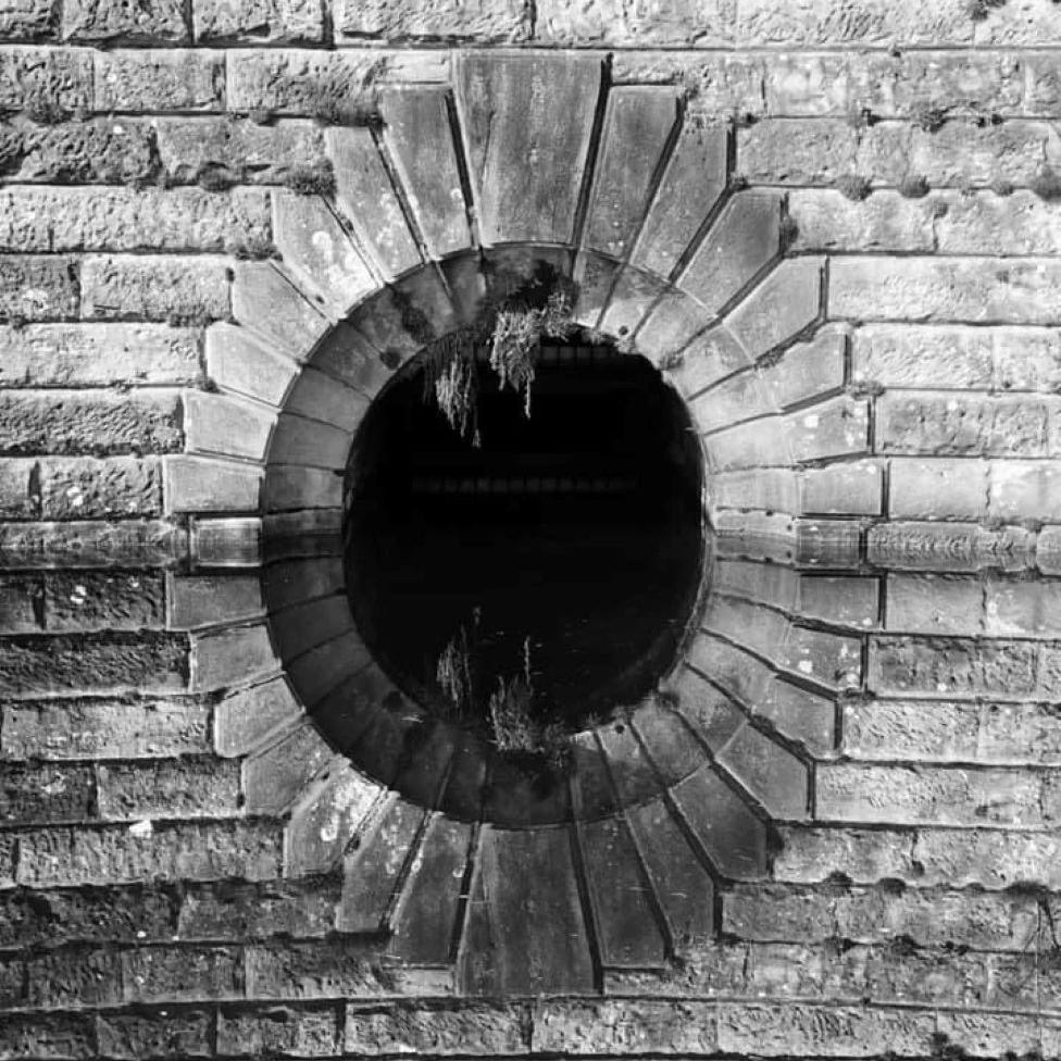 Archway reflected in water