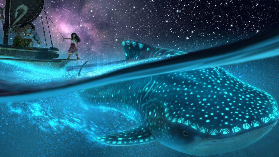 Moana and Maui on a boat with a luminescent whale underneath them in the sea