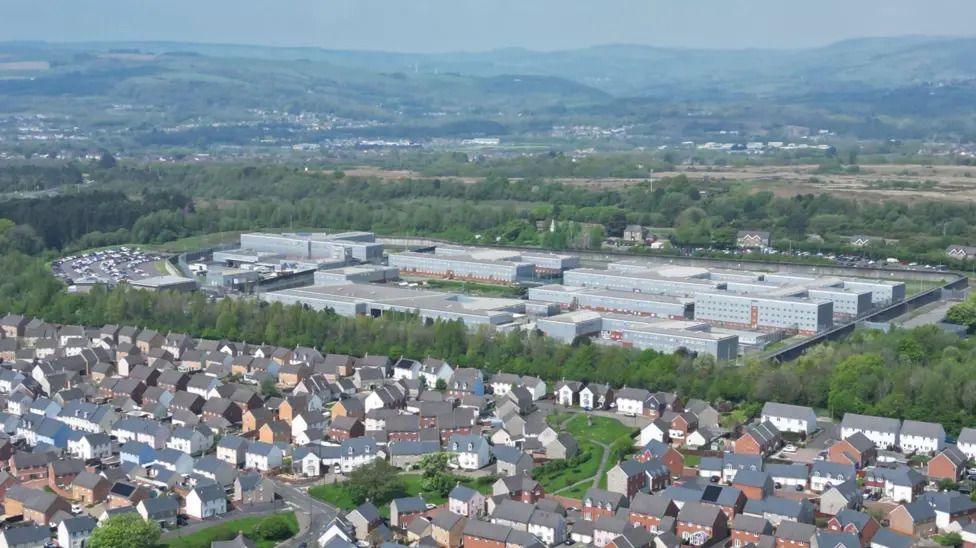 An aerial shot of HMP Parc with residential houses seen in front of it.