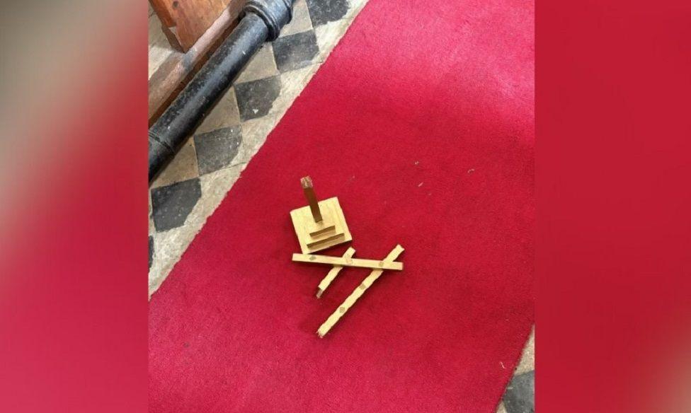 One of the main alter crosses left on the red floor after being broken