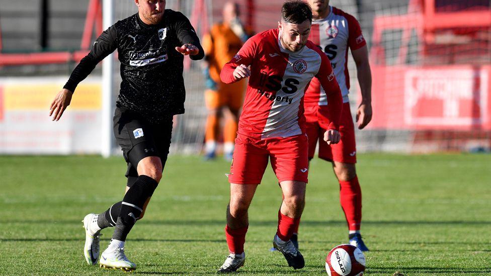 Barrow's Ritchie Bennett tussles with Ashton's Matty Regan