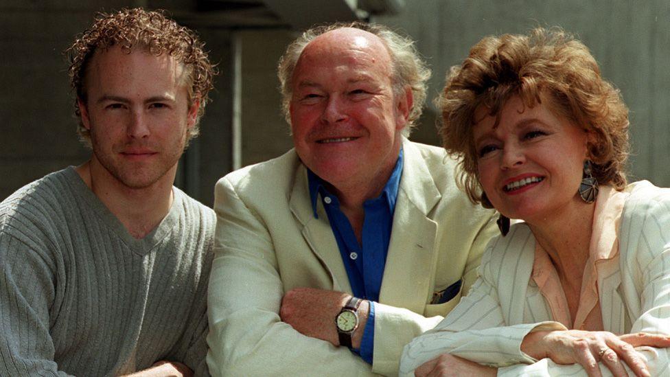 Sam and Timothy West and Prunella Scales posing together in 1999