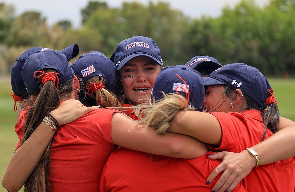 A tearful Jordan Karrh of the Dallas Baptist Patriots celebrates with team-mates after their victory in the NCAA DII women's golf championship in Boulder City, Nevada. Photo by Ian Maule