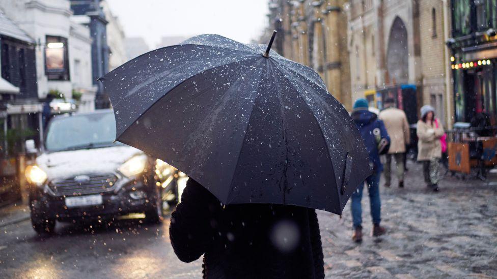 Person with umbrella in Brighton