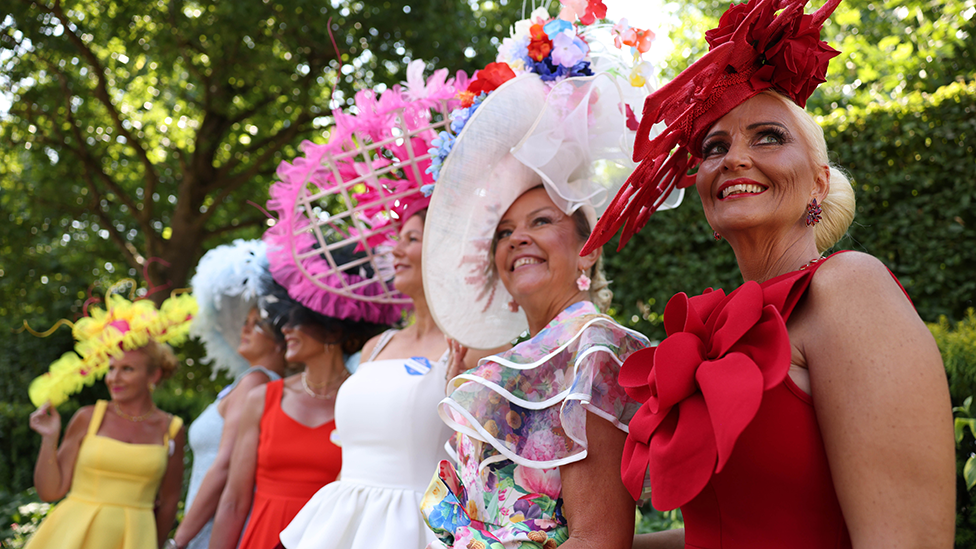 Women line-up in brightly coloured dresses at Ladies Day in Royal Ascot.