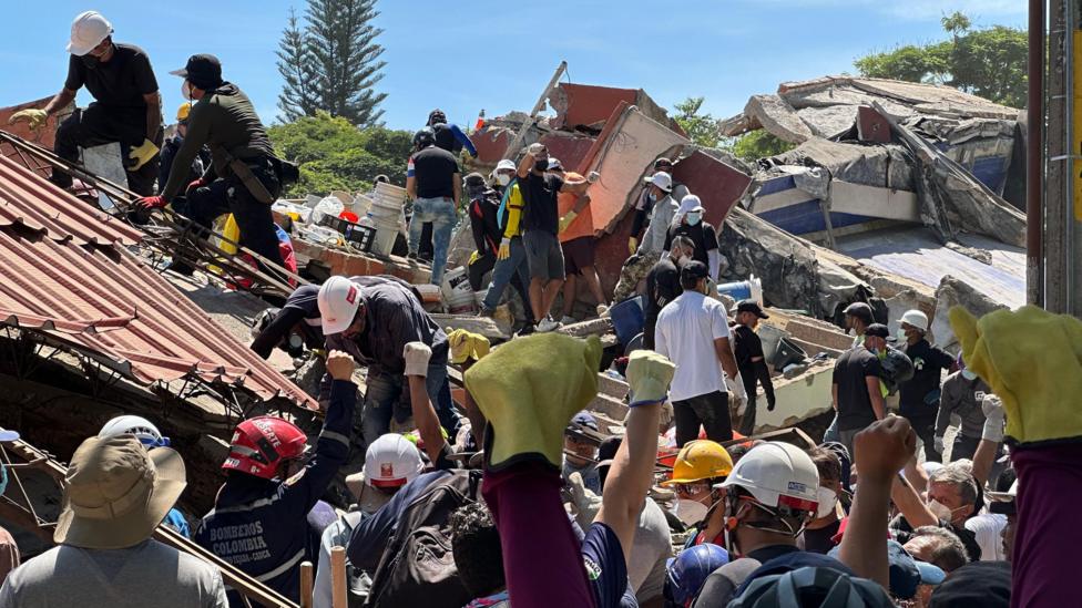 Anguish of Colombian brother at rubble of building being searched for earthquake survivors