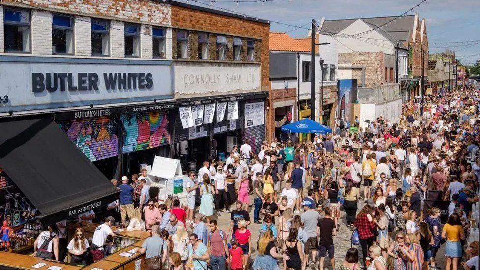 Crowds of people enjoy drinks in sunny weather as part of the Humber Street Sesh music festival in Hull.