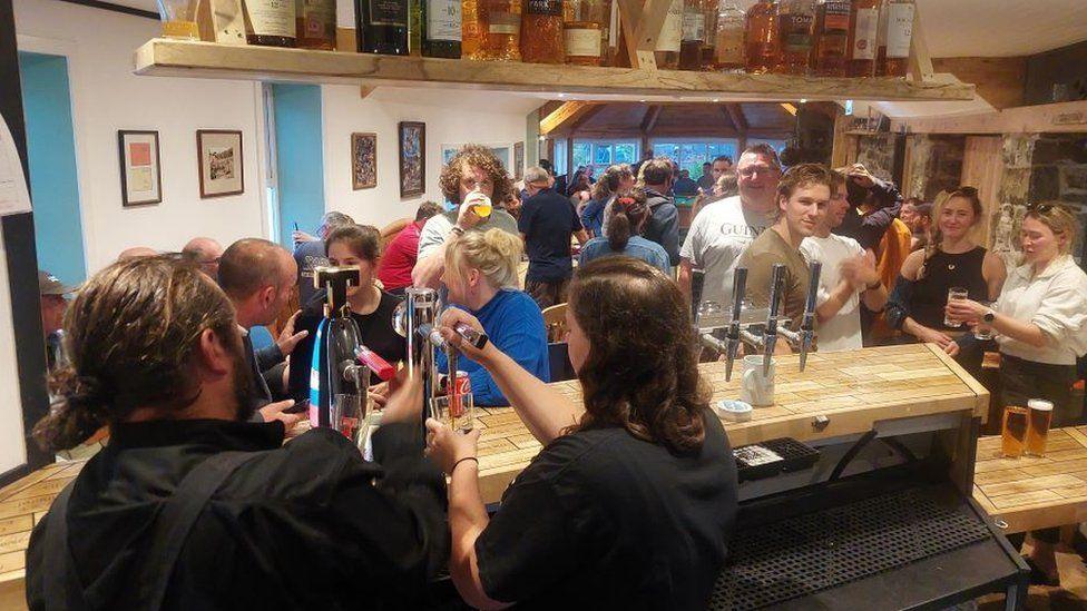 People inside The Old Forge on its first night under community ownership