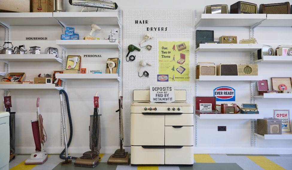 The interior of an electrical shop at Beamish museum, showing products such as hoovers, radios, cookers and hair dryers on sale